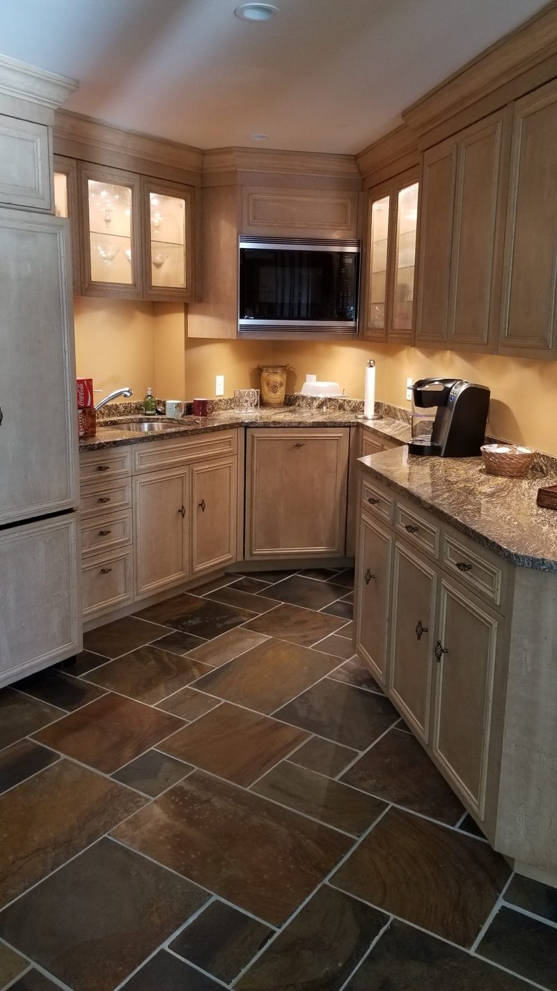 Cream bar cabinetry with under-cabinet lighting and a built-in microwave