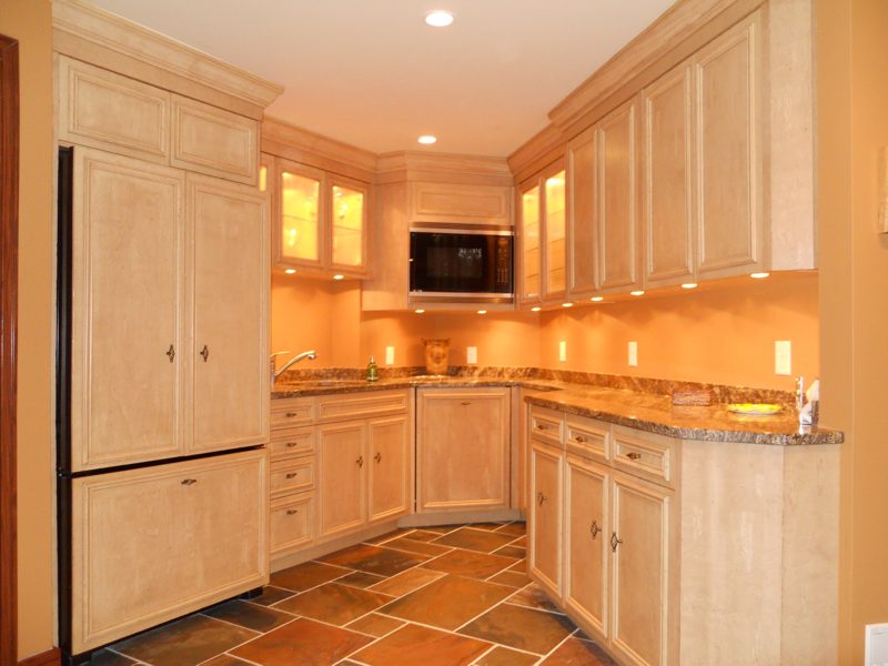 Light maple-look bar kitchen with a paneled refrigerator and granite counters
