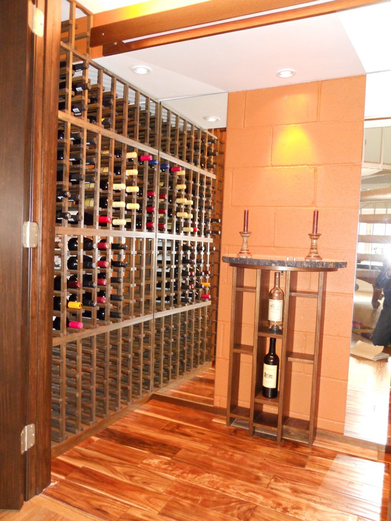 Wine room with dark wood racks and a center display stand