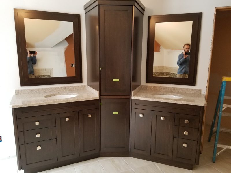 Espresso double vanity with a tall linen tower and matching framed mirrors