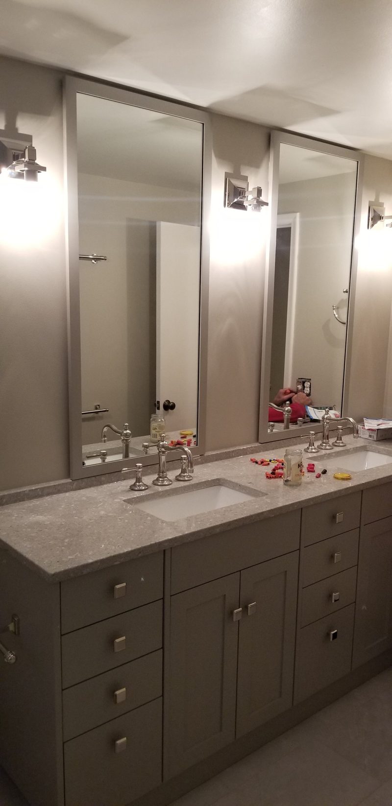 Gray shaker vanity with a marble countertop and two tall mirrors