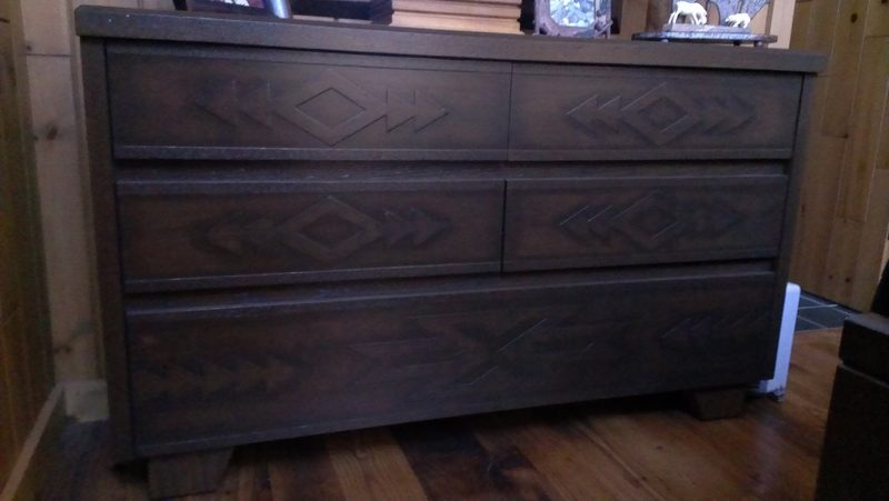 Front view of a dark wood dresser with carved diamond-pattern drawers