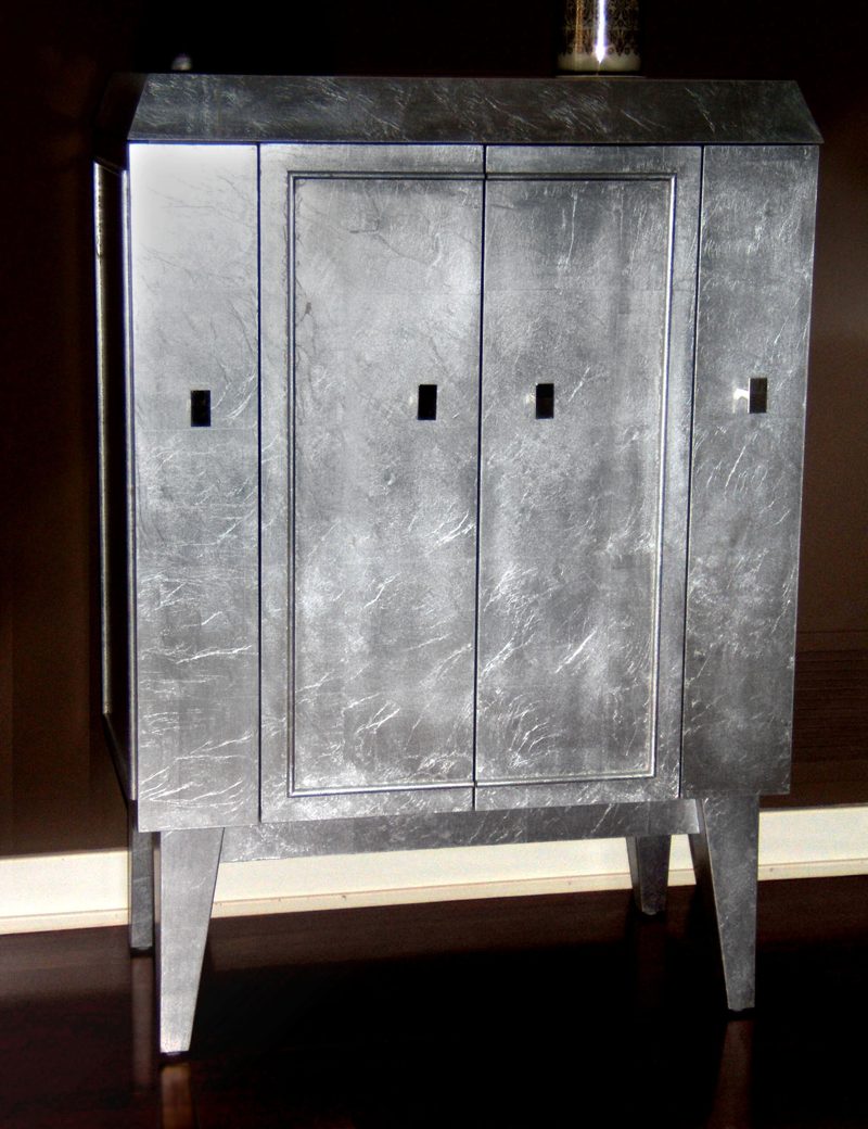 Silver leaf cabinet with two doors and tapered legs