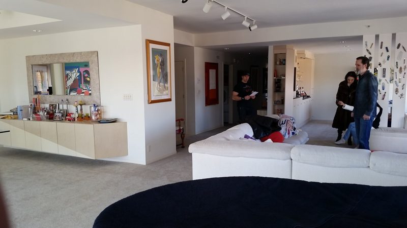 Open living area with a floating light wood buffet along the far wall