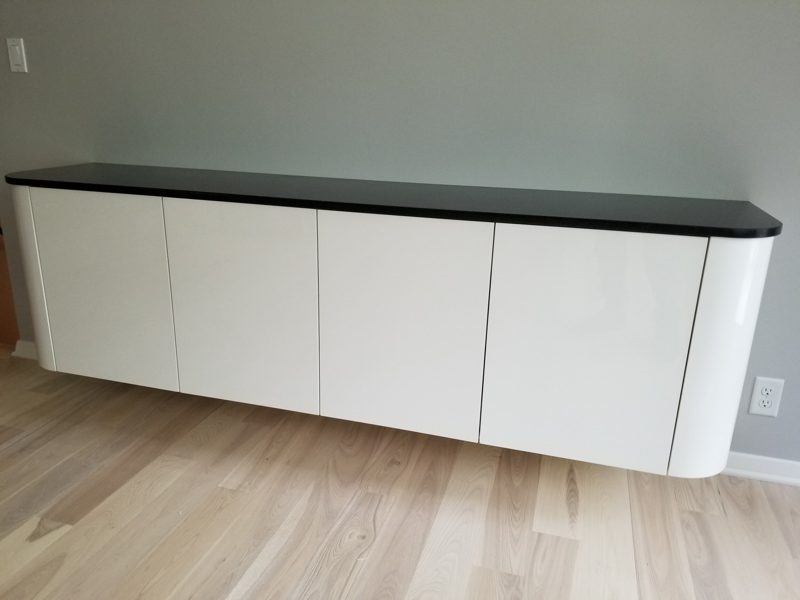 Floating white buffet with rounded ends and a black top