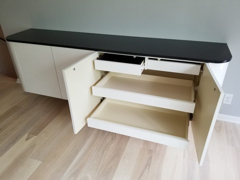 White floating buffet with doors open to reveal pullout drawers and shelves