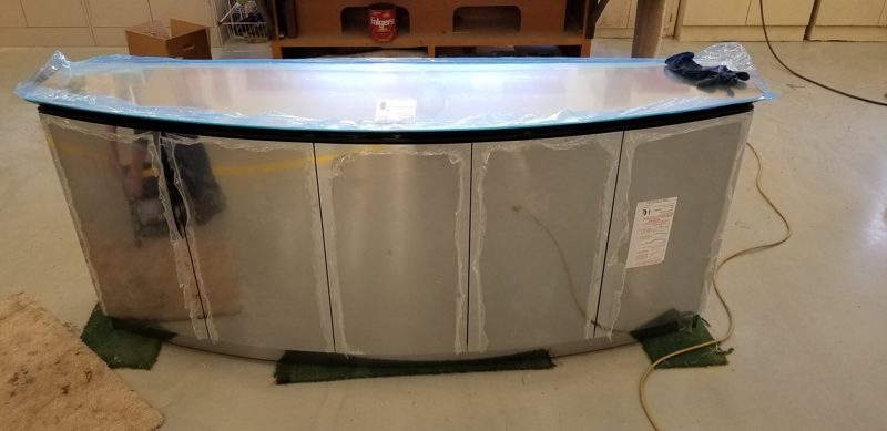 Curved brushed metal buffet cabinet under construction in the shop