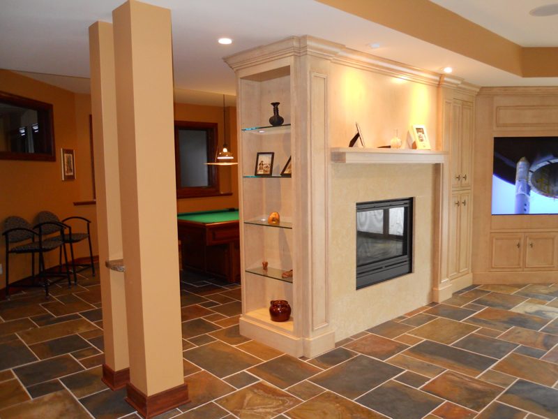 Cream fireplace built-ins with glass display shelves beside a column