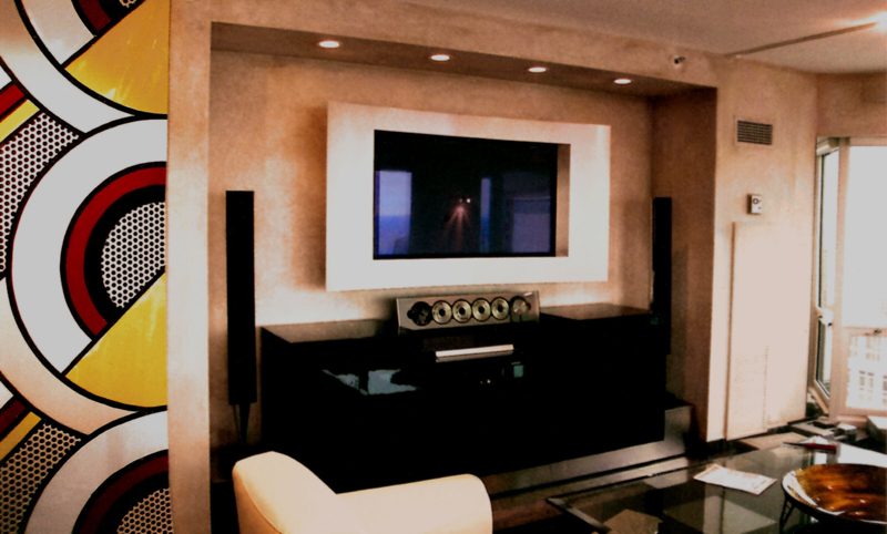 White TV frame above a low black media console in a living room