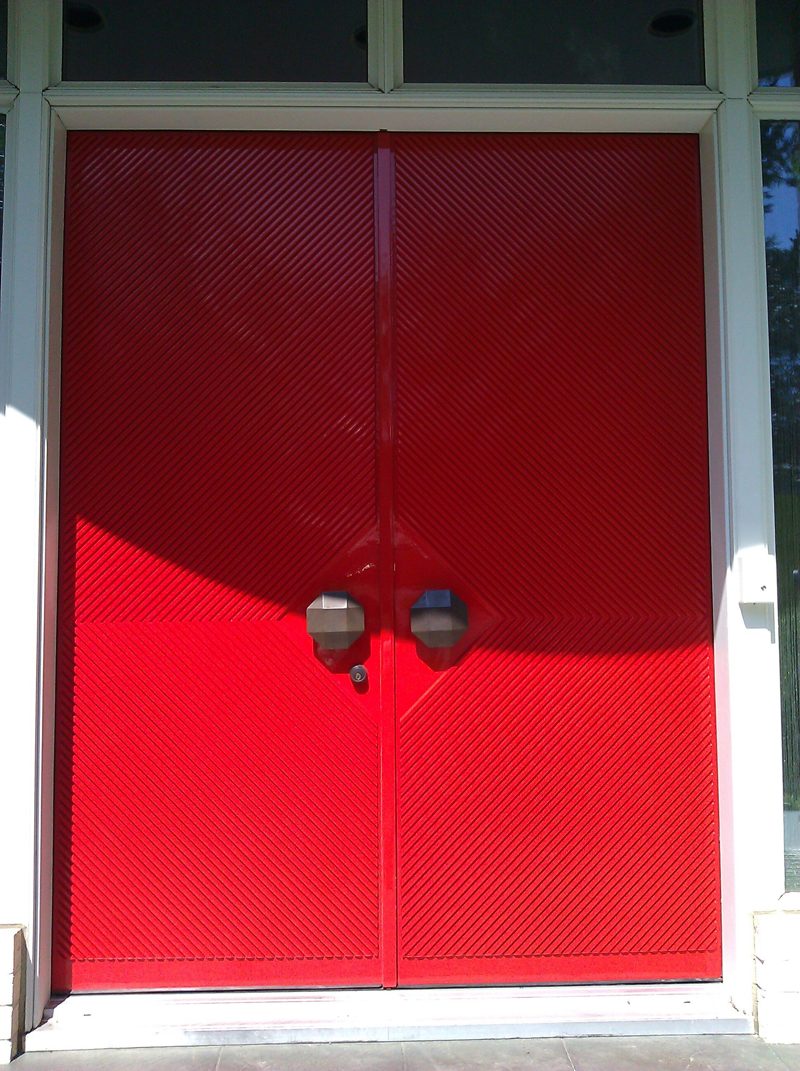 Red lacquered double doors with diagonal grooves and round pulls