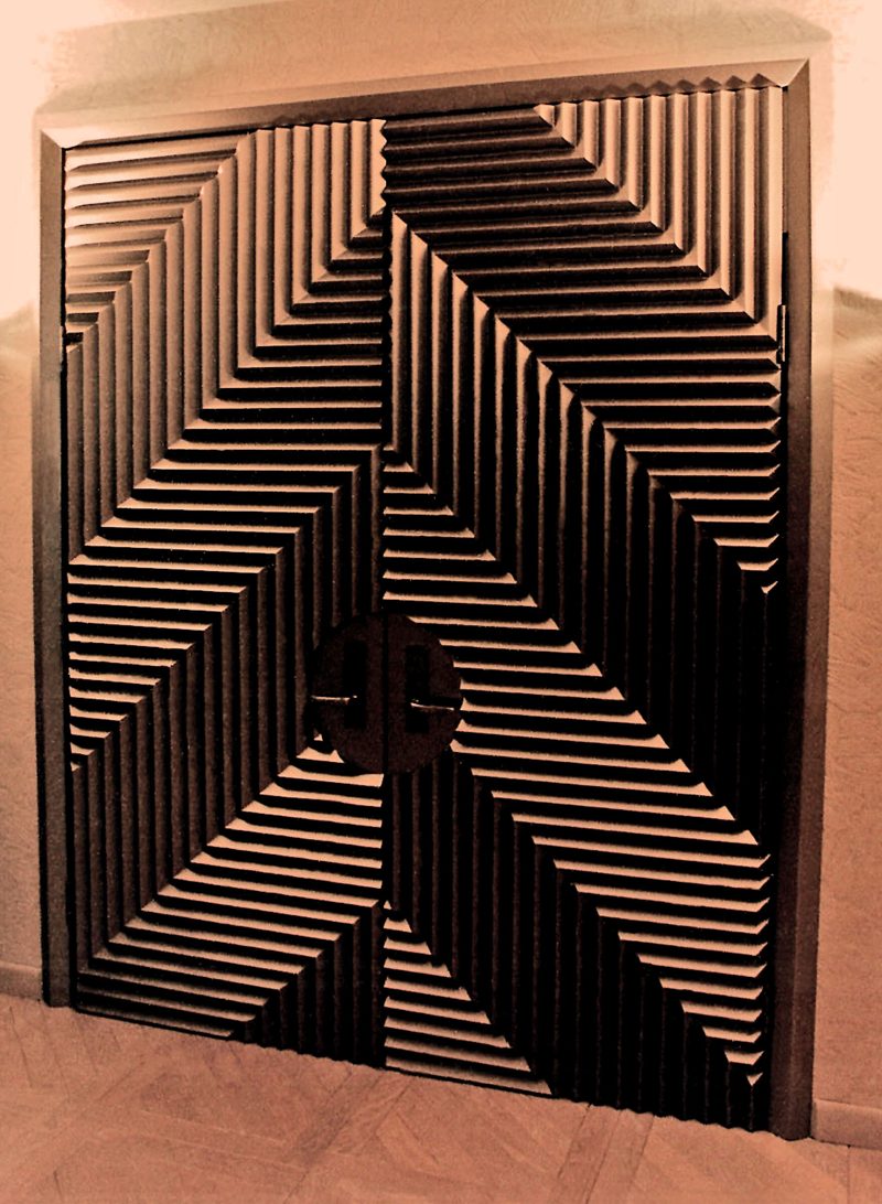 Dark double doors with a raised chevron-pattern relief
