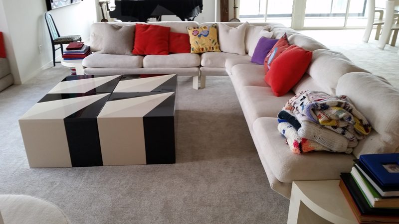 Black and cream striped ottoman in front of a cream sectional